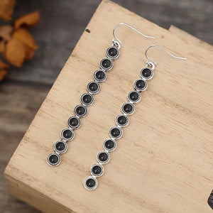 Linear drop earrings with black stones and silver alloy settings