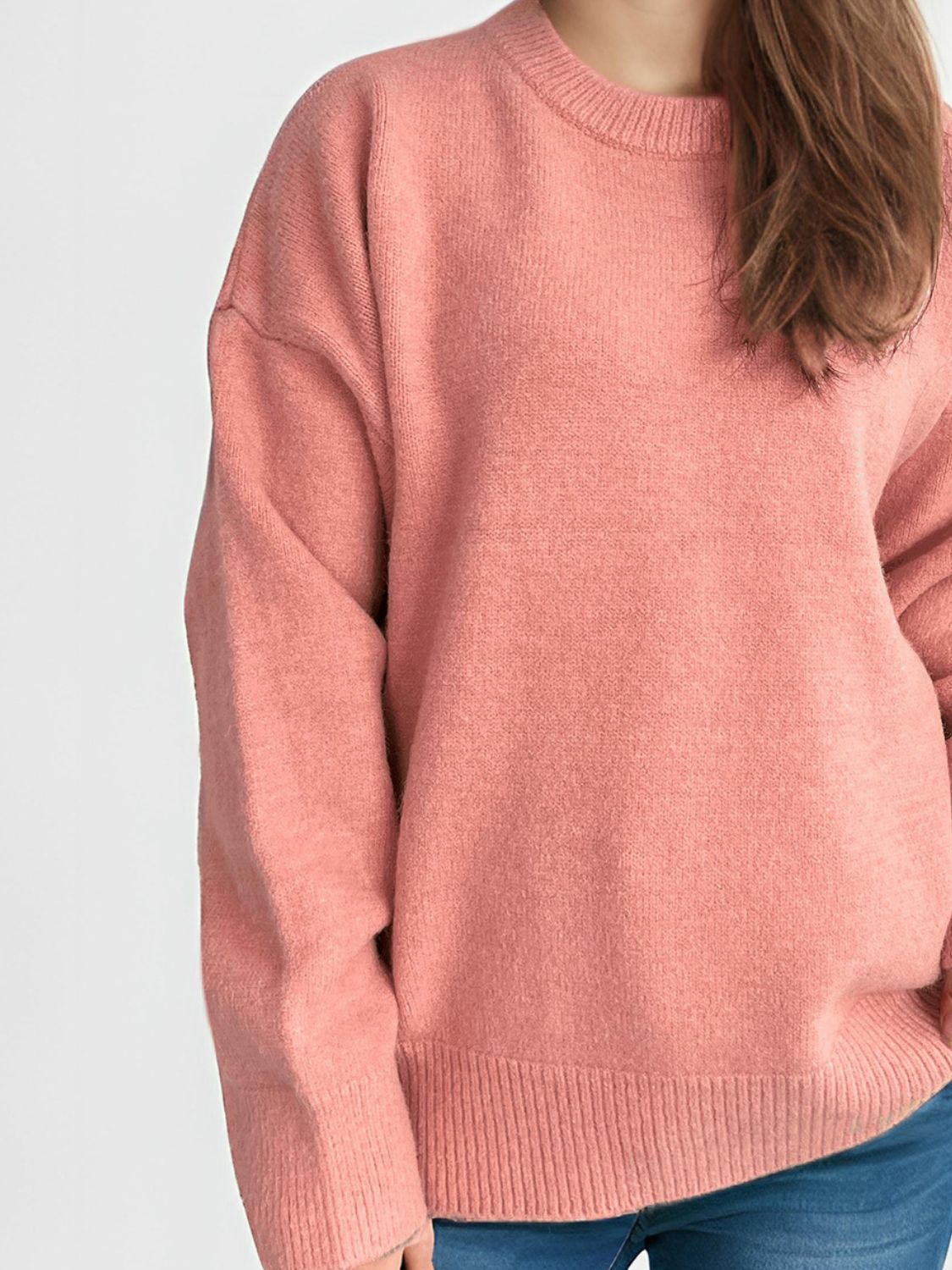 Oversized crewneck knit pullover sweater in Burnt Coral acrylic with ribbed cuffs and hem.