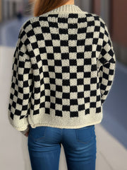 Checkerboard knit button-up cardigan in black and taupe acrylic with a relaxed fit.