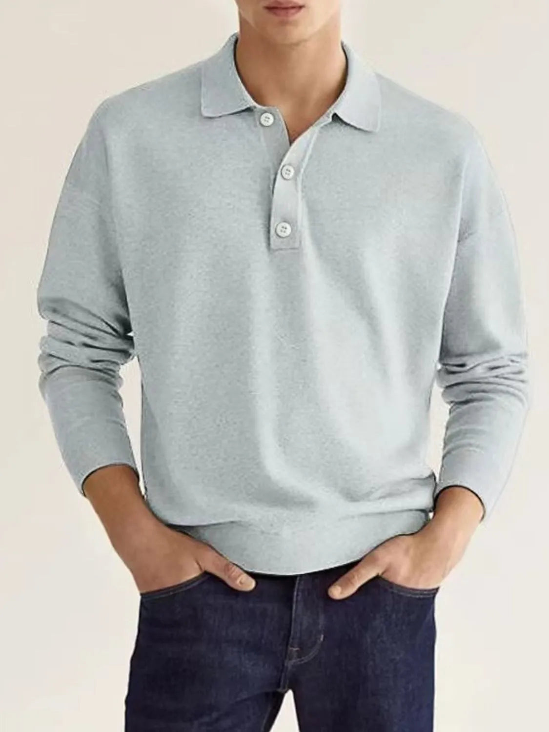Light gray knit polo shirt with button placket and long sleeves.