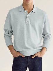 Light gray knit polo shirt with button placket and long sleeves.