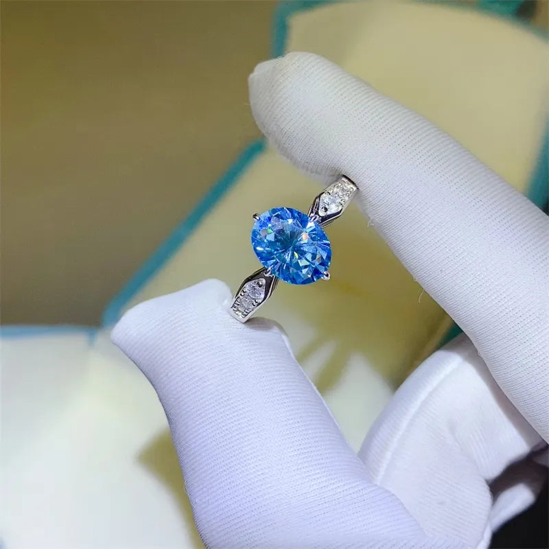 Sterling silver ring with oval blue moissanite and diamond halo detail