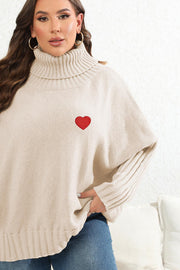 Ivory turtleneck knit sweater with red heart appliqué and ribbed sleeves.