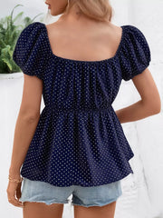 Navy polka dot maternity blouse with puff sleeves and square neckline.