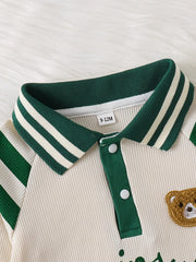 Baby one-piece with beige ribbed fabric, green striped collar, and bear applique.