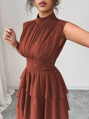 Sleeveless ruffle tiered dress in dark red with ruched bodice and high neckline.