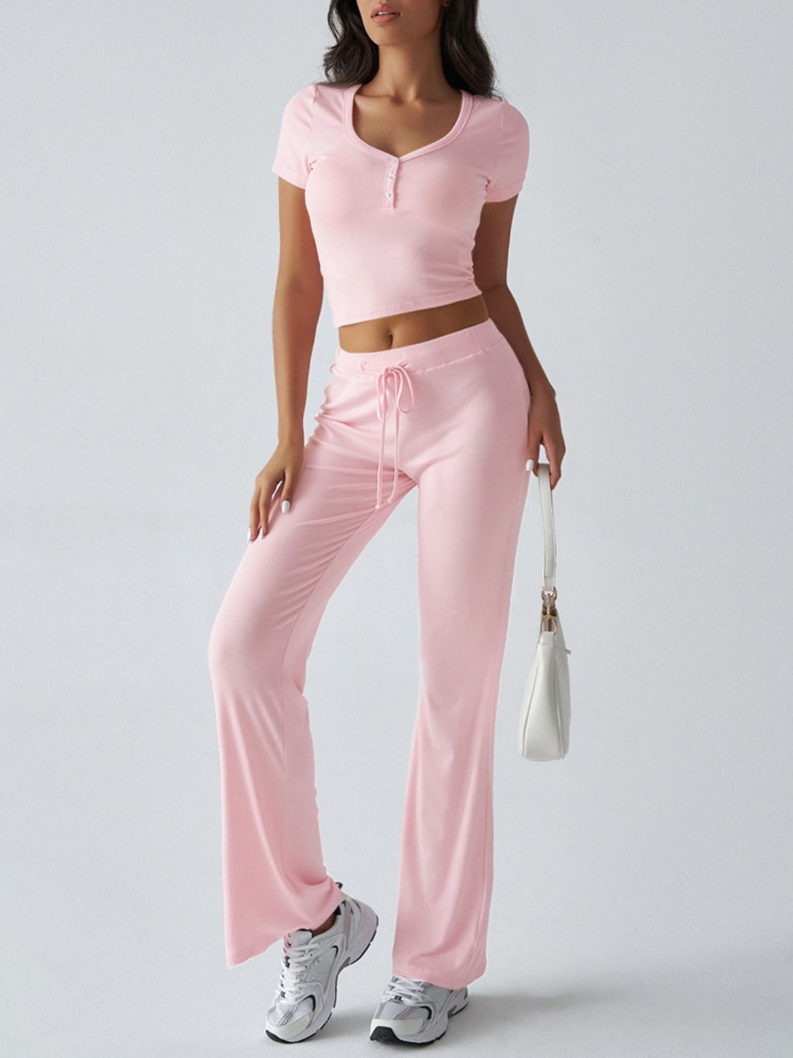 Blush pink button-front crop top and flared lounge pants with drawstring waist.