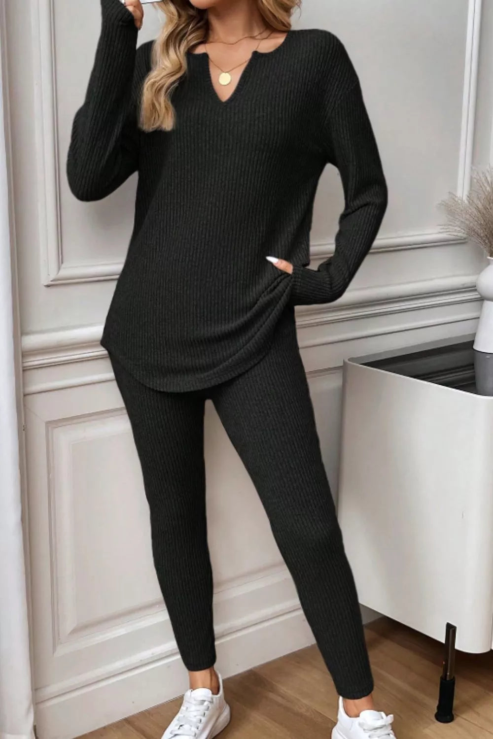 Black ribbed notched top and pants set with long sleeves and a relaxed fit.