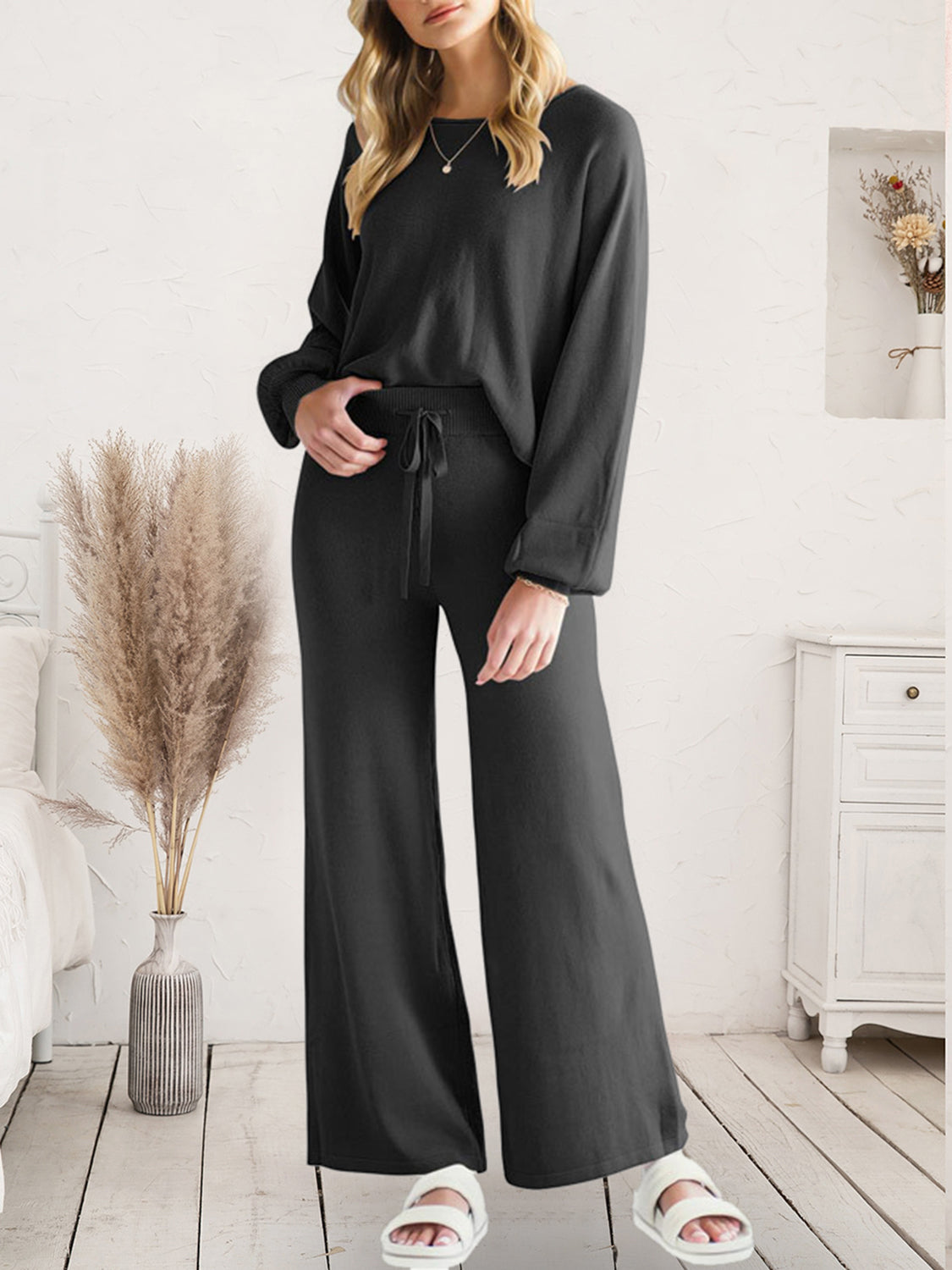 Black acrylic loungewear set with wide-leg pants and crewneck top, featuring a drawstring waist.