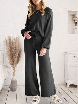 Black acrylic loungewear set with wide-leg pants and crewneck top, featuring a drawstring waist.