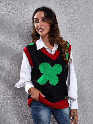 Black acrylic knit vest with green clover intarsia pattern and red trim