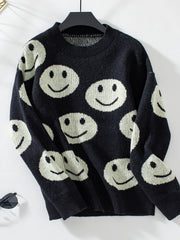 Black knit sweater with allover white smiley face intarsia pattern and crew neck.