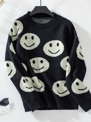 Black knit sweater with allover white smiley face intarsia pattern and crew neck.