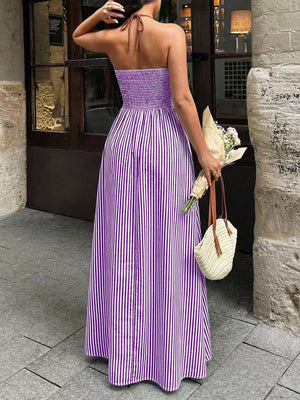 Purple striped halter neck maxi maternity swim dress with smocked bodice and flowing skirt.