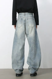 Faded light blue baggy denim jeans with a relaxed fit and distressed details.
