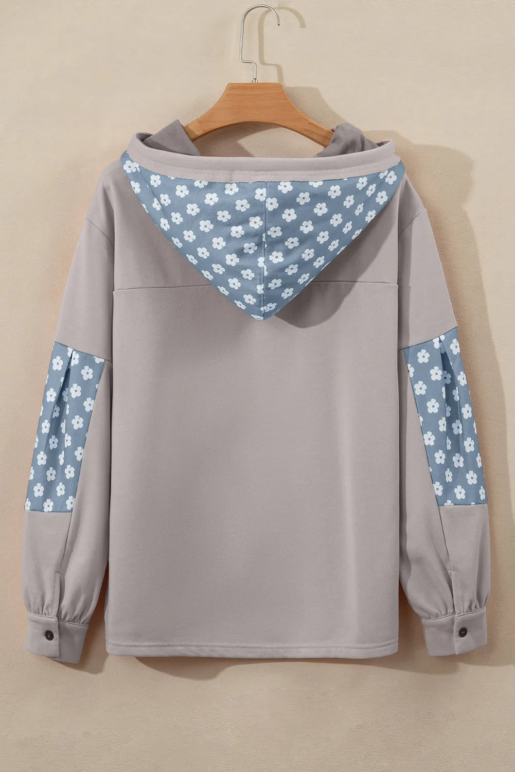 Tan floral patchwork hoodie with a hood and button cuffs.