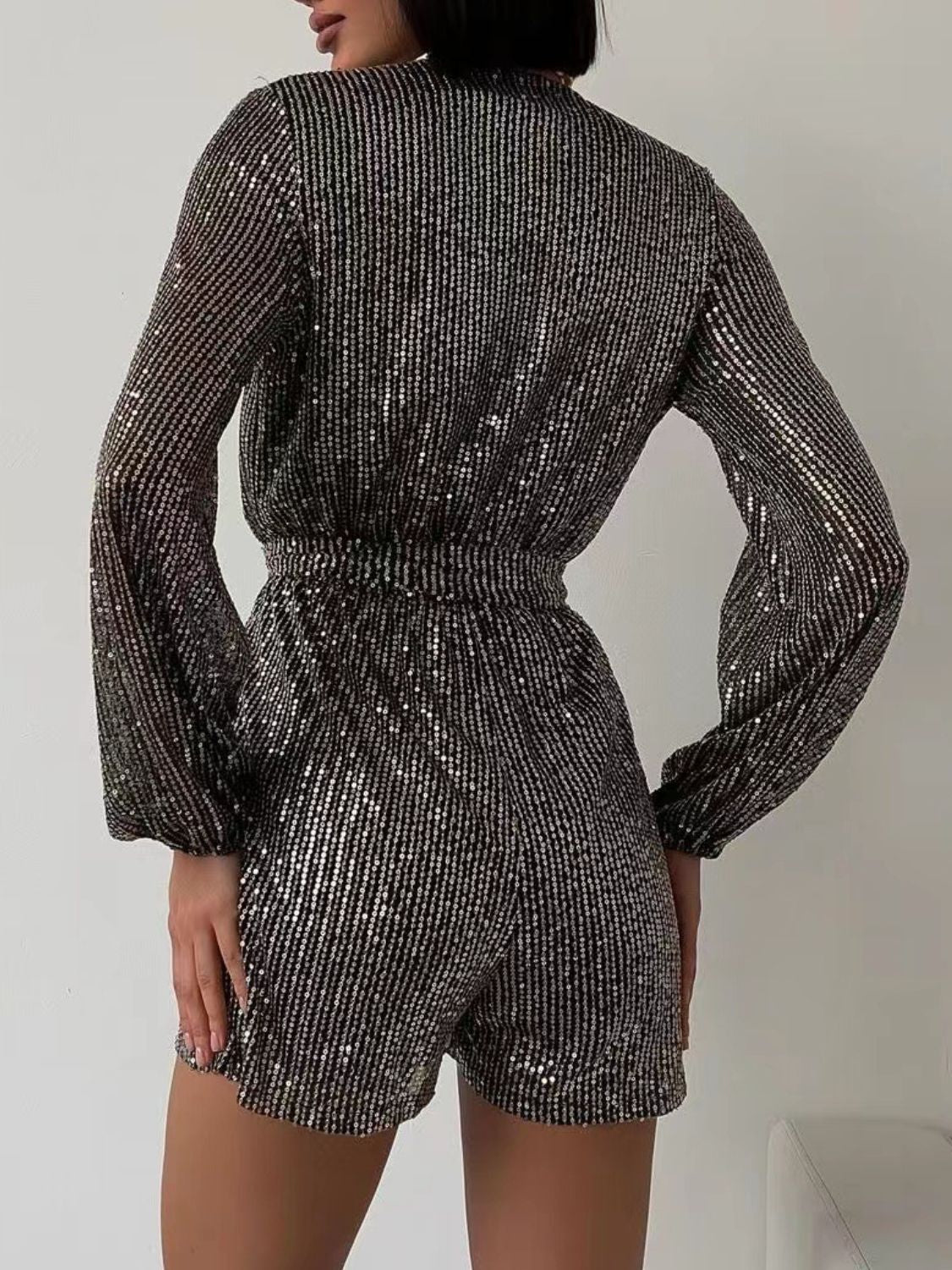 Black/Silver sequin romper with blouson sleeves and wrap detail.