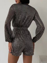 Black/Silver sequin romper with blouson sleeves and wrap detail.