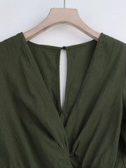 Olive green cotton romper with V-neck and back keyhole detail.