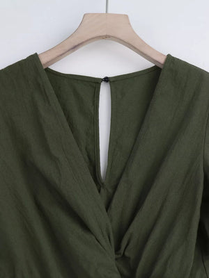 Olive green cotton romper with V-neck and back keyhole detail.