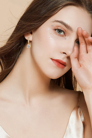 Gold drop earrings with clear crystal prisms and textured hoops.