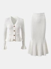 White knit cardigan with ruffled hem and bell sleeves, paired with a matching mermaid skirt.