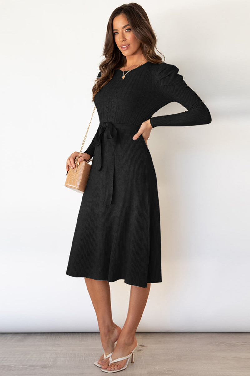 Black cable knit midi dress with self-tie belt and long sleeves.