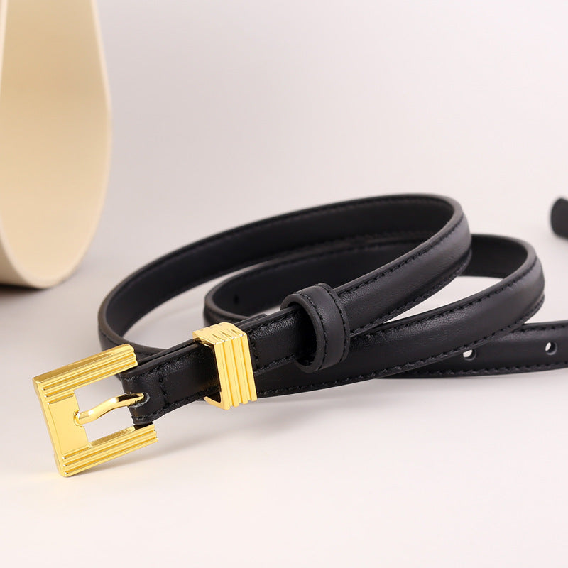 Skinny black leather belt with a gold buckle and gold keeper loop.