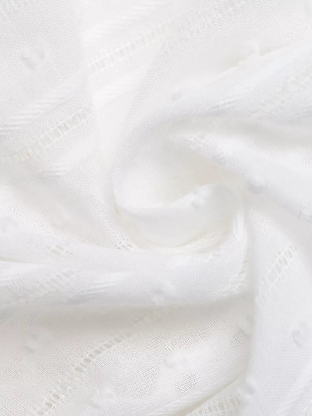 White lace-trimmed tie-front sleeveless maternity blouse with textured dot pattern