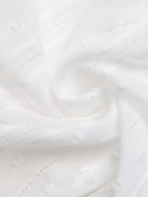 White lace-trimmed tie-front sleeveless maternity blouse with textured dot pattern