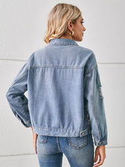 Light wash denim trucker jacket with distressed details and button cuffs.