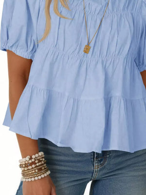Sky blue maternity blouse with puff sleeves, smocked bodice and tiered ruffle hem.