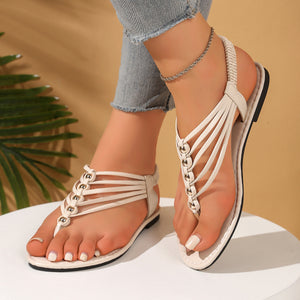Off-white studded slim strap toe post sandals with multiple thin straps and a comfortable elastic heel strap.