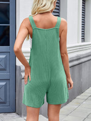 Green ribbed romper overalls with white pinstripes and wide straps.