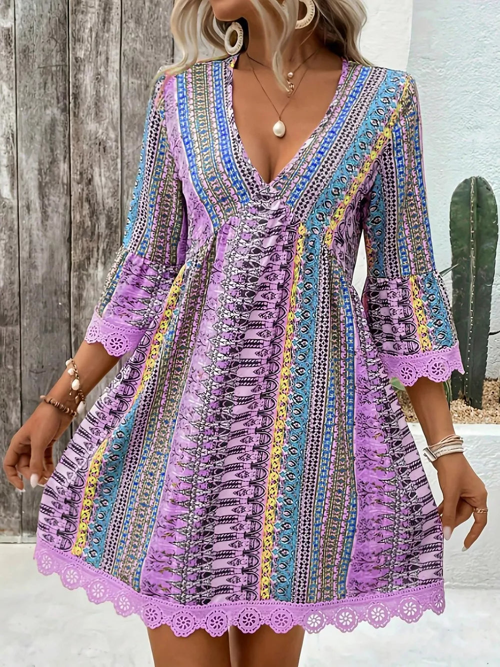 Bohemian printed light purple v-neck dress with bell sleeves and lace trim.