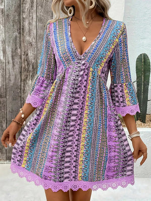 Bohemian printed light purple v-neck dress with bell sleeves and lace trim.