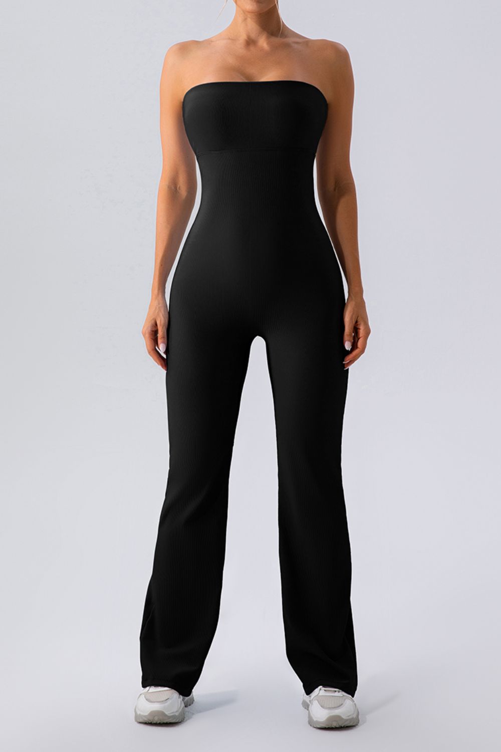Black ribbed bandeau flare leg jumpsuit with a seamless fit.