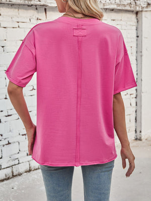 Oversized hot pink cotton tee with seam detail and rolled sleeves.