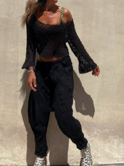 Black asymmetric crochet crop top with bell sleeves and scoop neck.