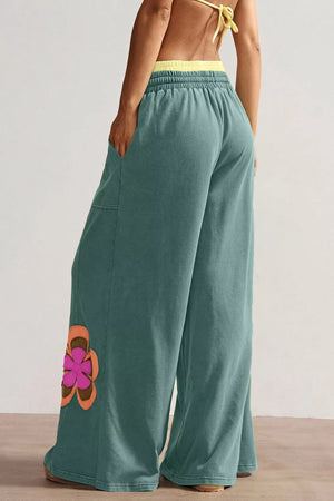 Teal cotton sweatpants with floral applique and drawstring waist.