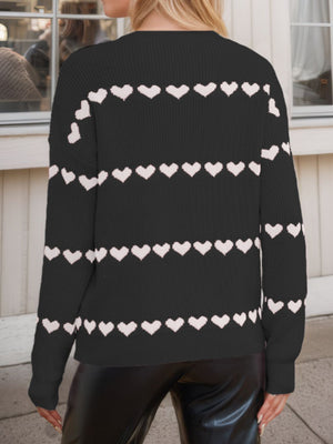Black knit sweater with white heart stripes, long sleeves, crew neck.