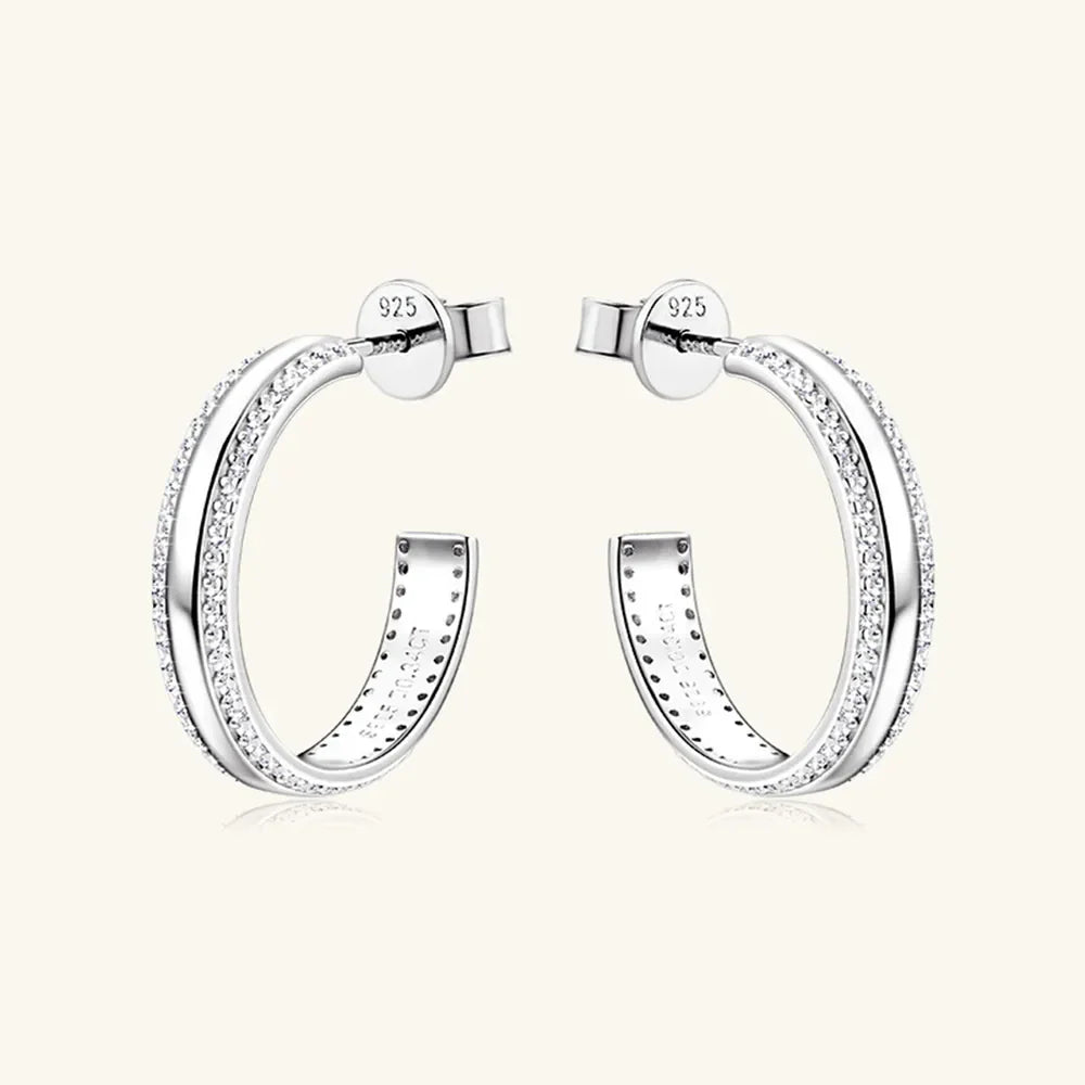Silver pavé moissanite C-hoop earrings in sterling silver with detailed inner engraving.