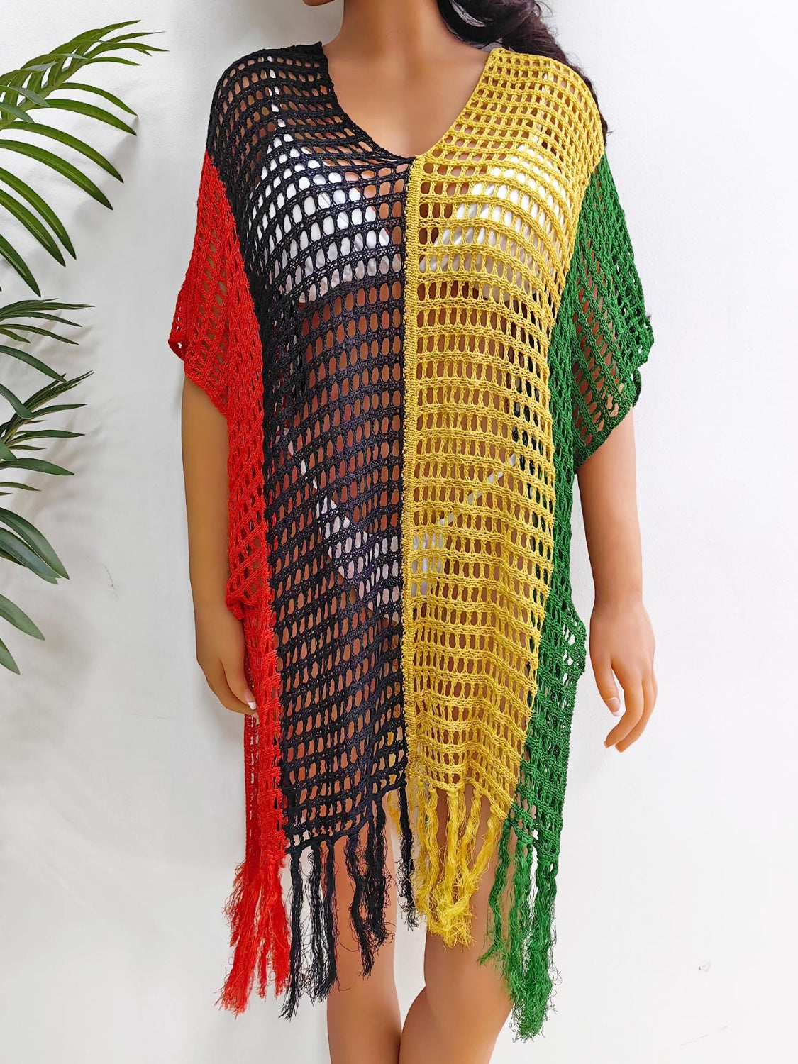 Colorblock crochet cover-up with fringe in red, black, yellow, and green.