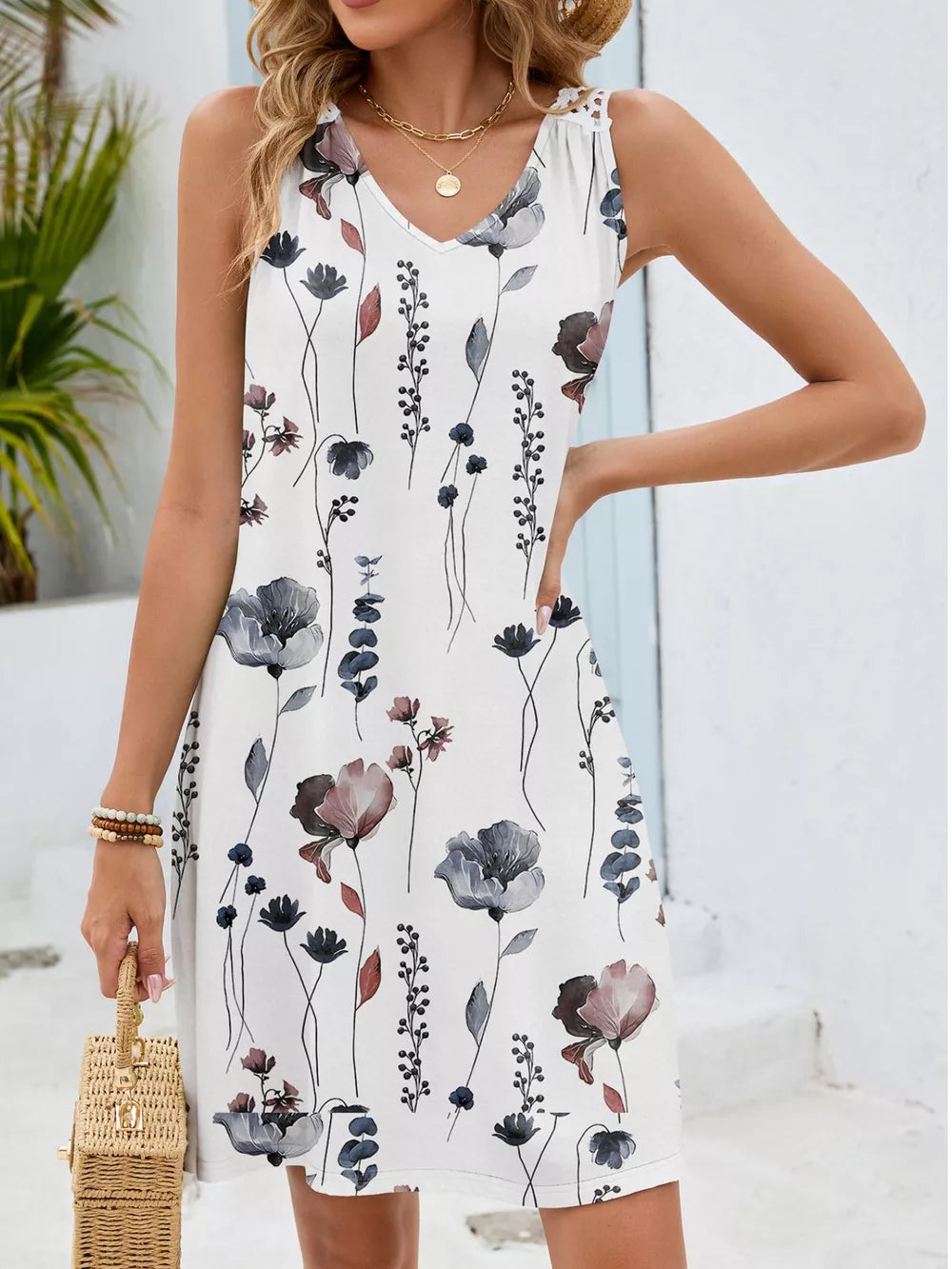 White botanical print mini dress with V-neck and crochet detail on straps.