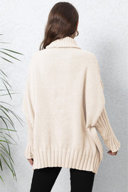 Beige knit turtleneck sweater with batwing sleeves and ribbed details.