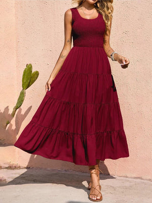 Burgundy smocked bodice ruffled maxi dress with tiered skirt and scoop neck.