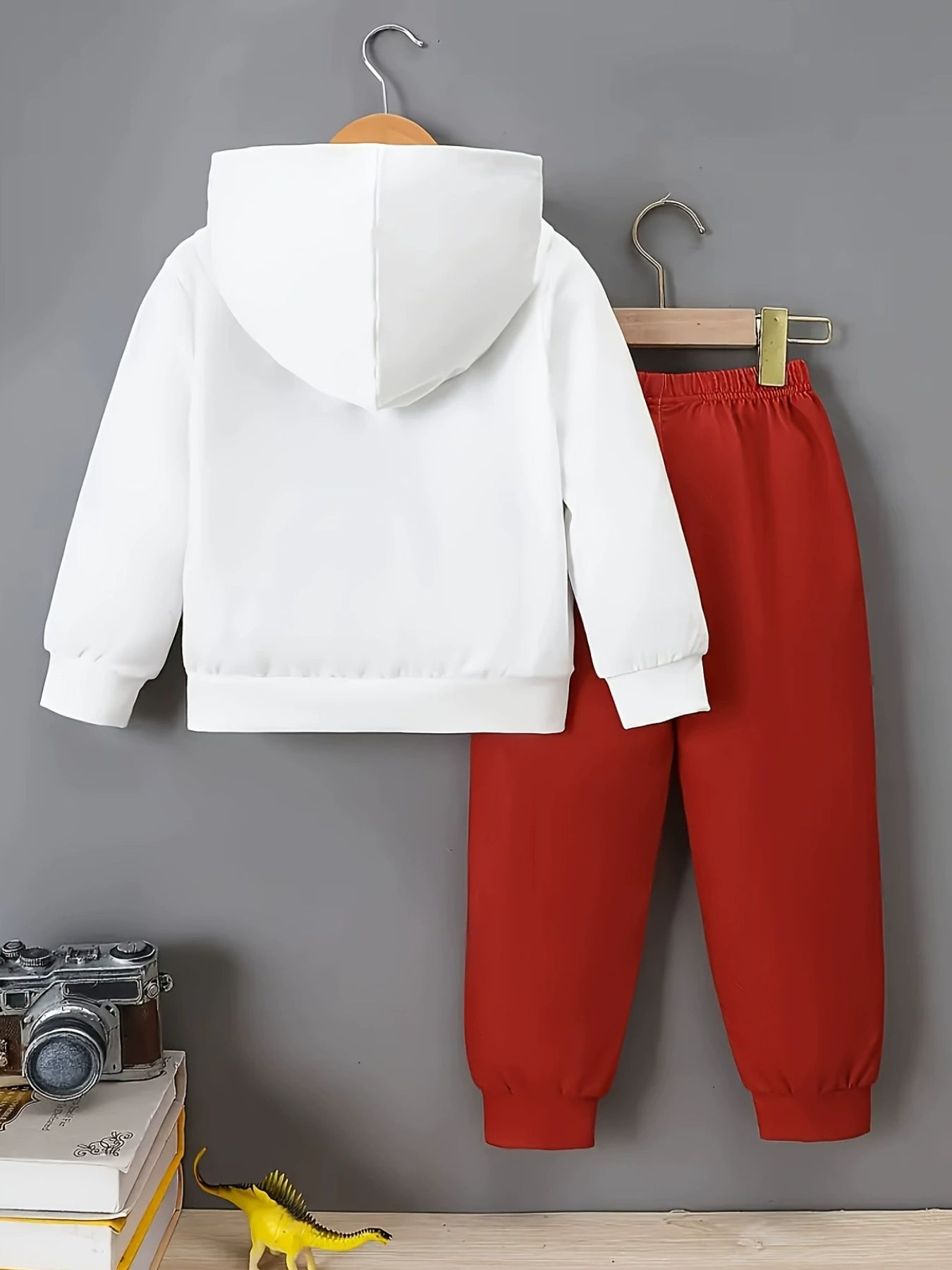 Baby white hoodie and red pants set with dinosaur graphic detail.