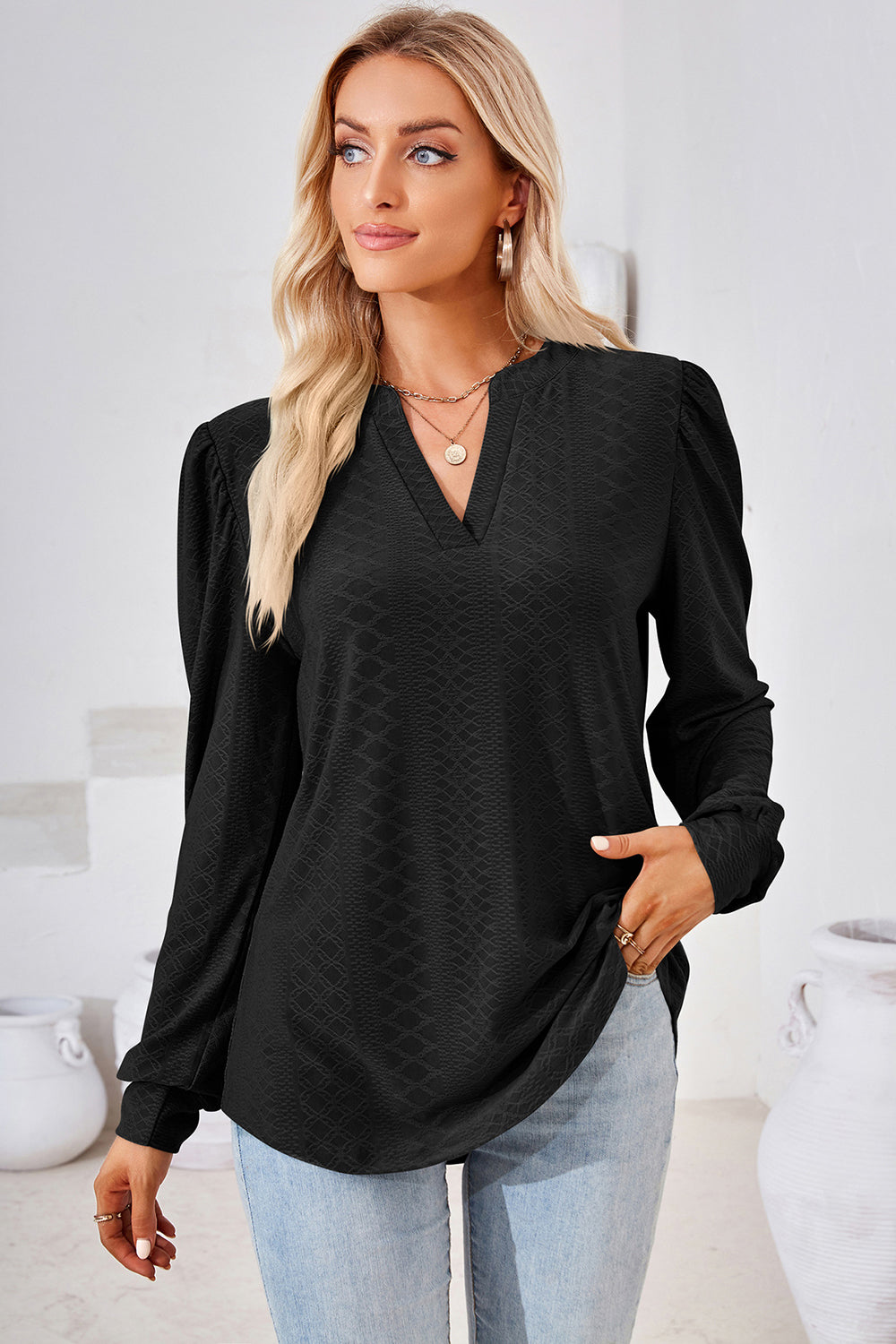 Black textured puff sleeve henley blouse with V-neck and long sleeves