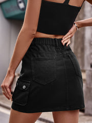 Black denim mini skirt with cargo pockets and elastic waistband.