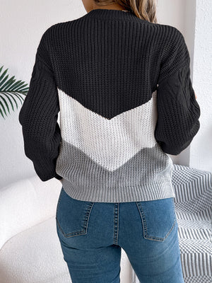 Chevron cable knit sweater in black, white, and grey with cable knit sleeves.